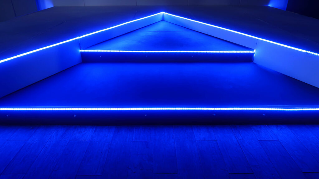 Glowing Blue Brilliance: Mesmerizing LED 4K Wallpaper Illuminating the Background