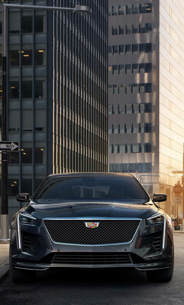 Cadillac Elegance Amidst Modern Skyscrapers: Captivating iPhone Snapshot Wallpaper