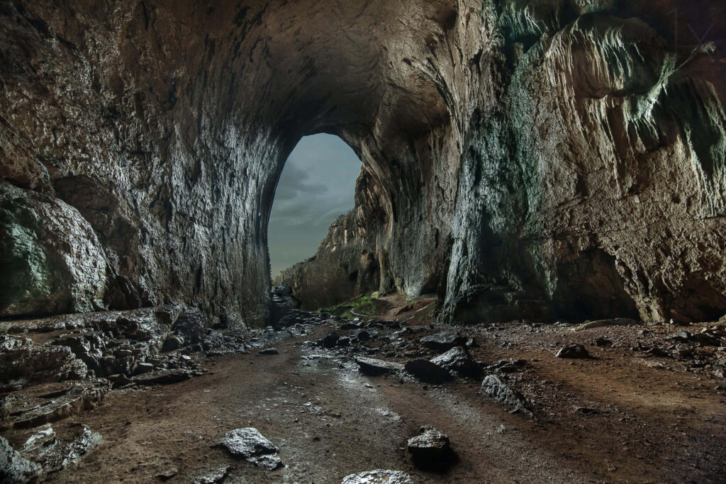 Mystical Cave Entrance: Rugged Rocks & Shadowy Passageway Wallpaper