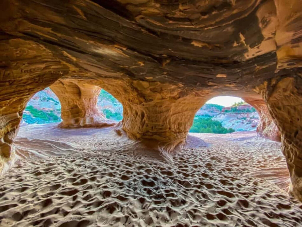Enchanting Cave Wallpaper: Eroded Sandstone & Lush Greenery