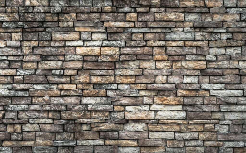 Textured Elegance: Exploring the Intricate Details of a Macro Gray Stone Wall Wallpaper