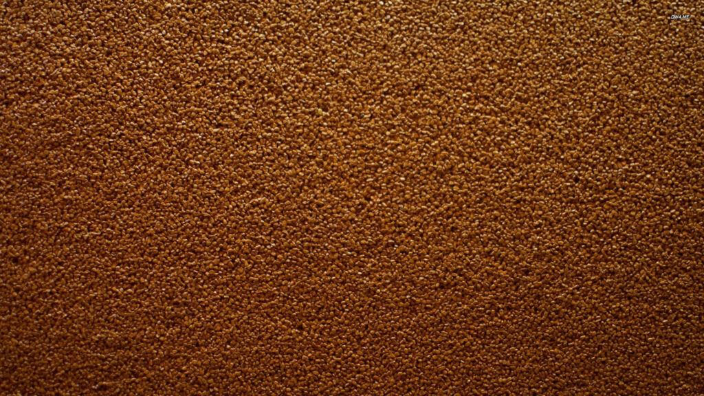 Fine brown sand texture wallpaper macro shot with intricate granular natural tones background