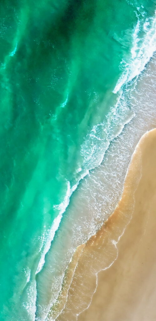 Seaside Bliss: Captivating Apple-Inspired HD Beachscape for your Mobile Wallpaper