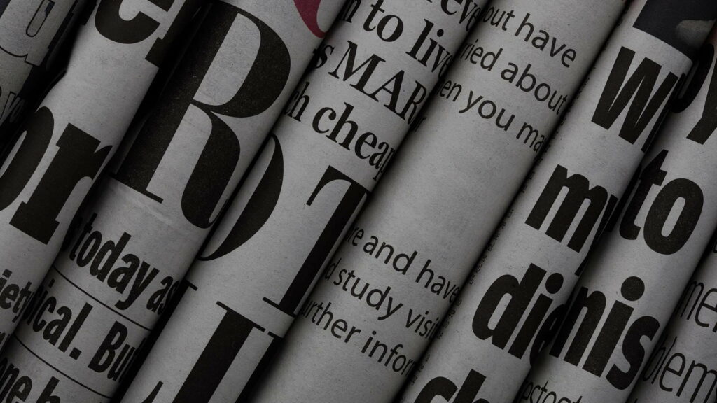 Ink-Stained Chronicles: A Monochromatic Tapestry of Newspaper Tales Wallpaper