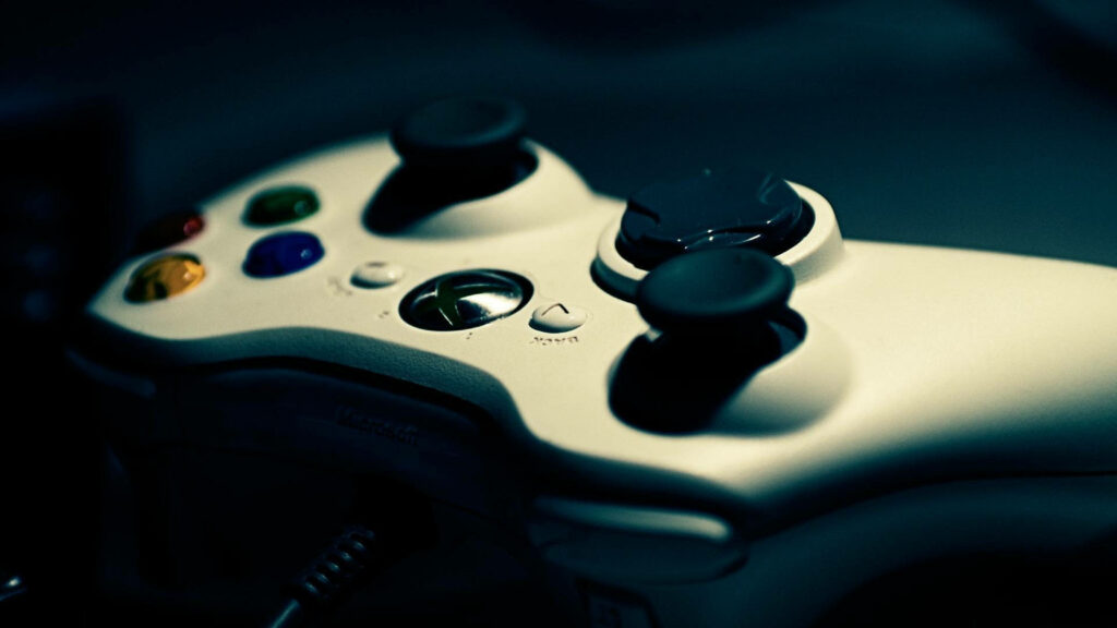 Snapshot of a White Xbox Controller Against a Mesmerizing Black Canvas Wallpaper