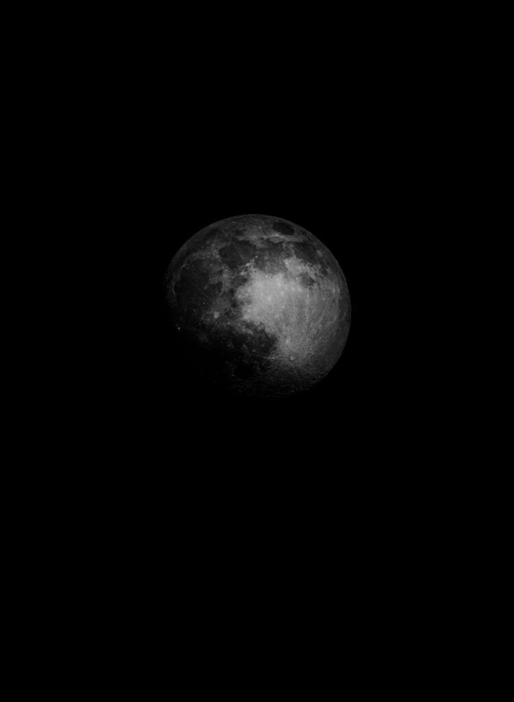 Dark Moon Rising Wallpaper: Mysterious Glow & Textured Background