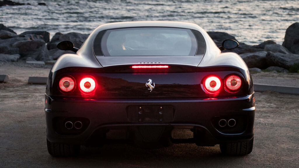 Roaring Elegance: Unleashing the Allure of the Red Ferrari 360 Modena on the Open Road Wallpaper