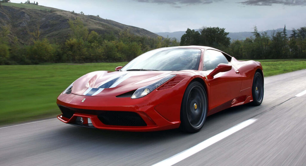 Exuding Performance and Style: Thrilling Action Shot of a Mind-Blowing Red Ferrari 458 Speciale Wallpaper