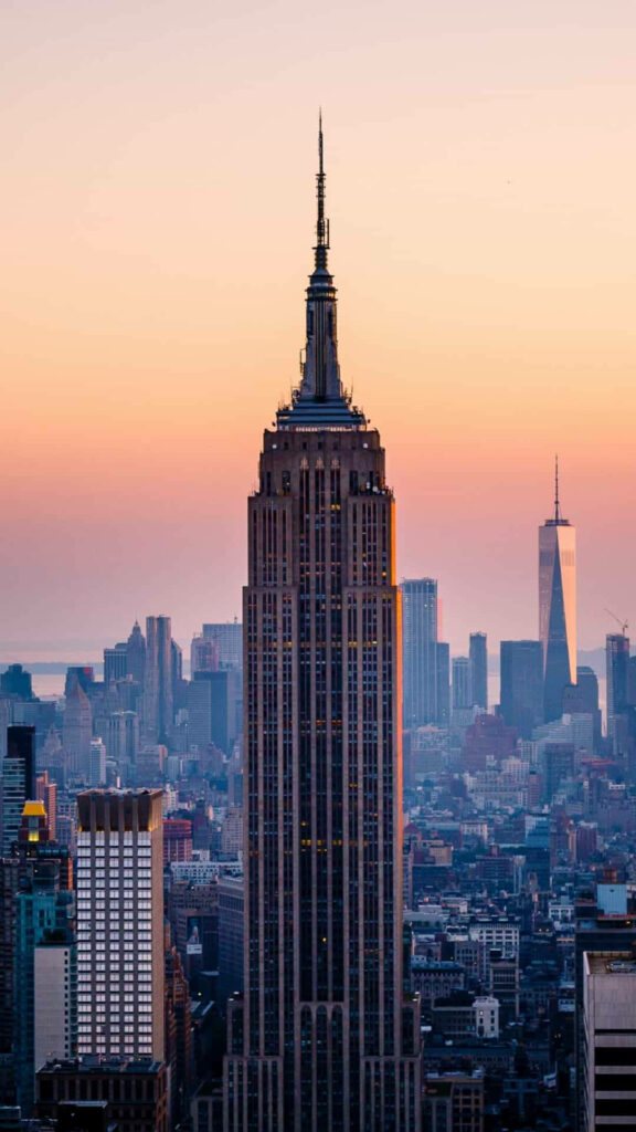 Glorious Skyline Symmetry: Empire State Building Standing Tall Amidst New York City's Capture Wallpaper