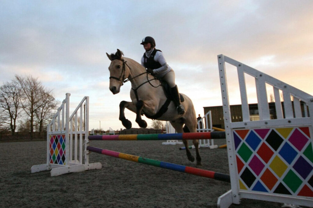 Stunning Equestrian Wallpaper: Horse & Rider Show Jumping Under Sky