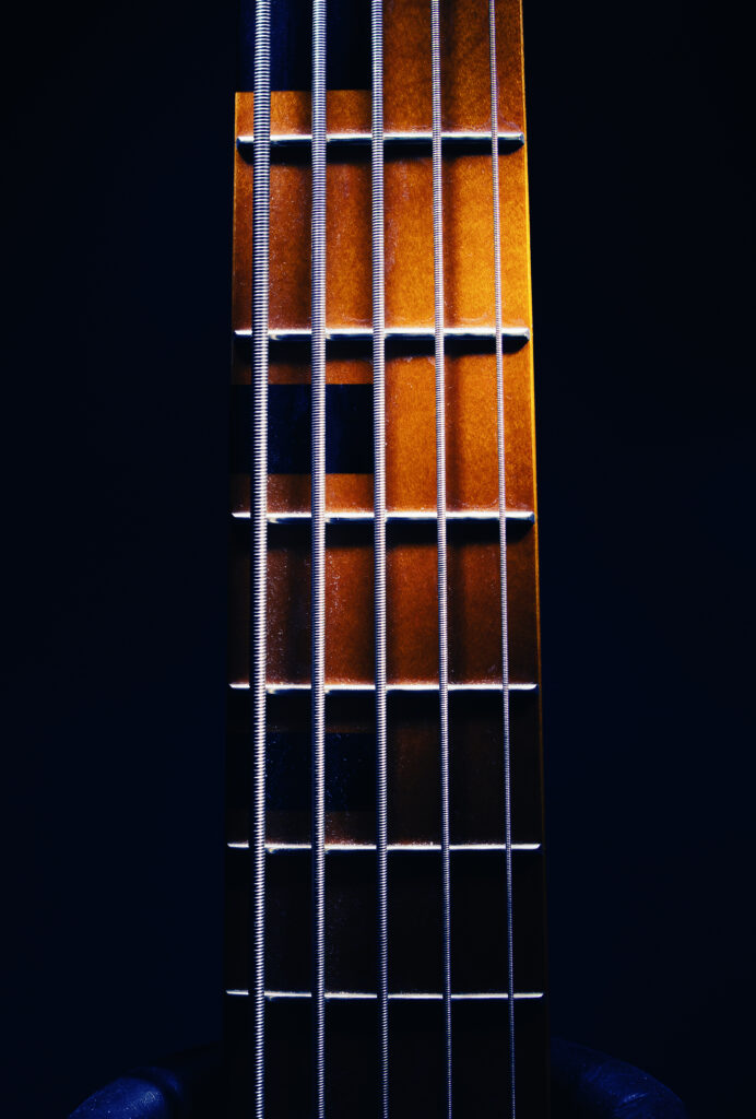 Close-Up Guitar Neck Wallpaper: Warm Glow & Musical Aura