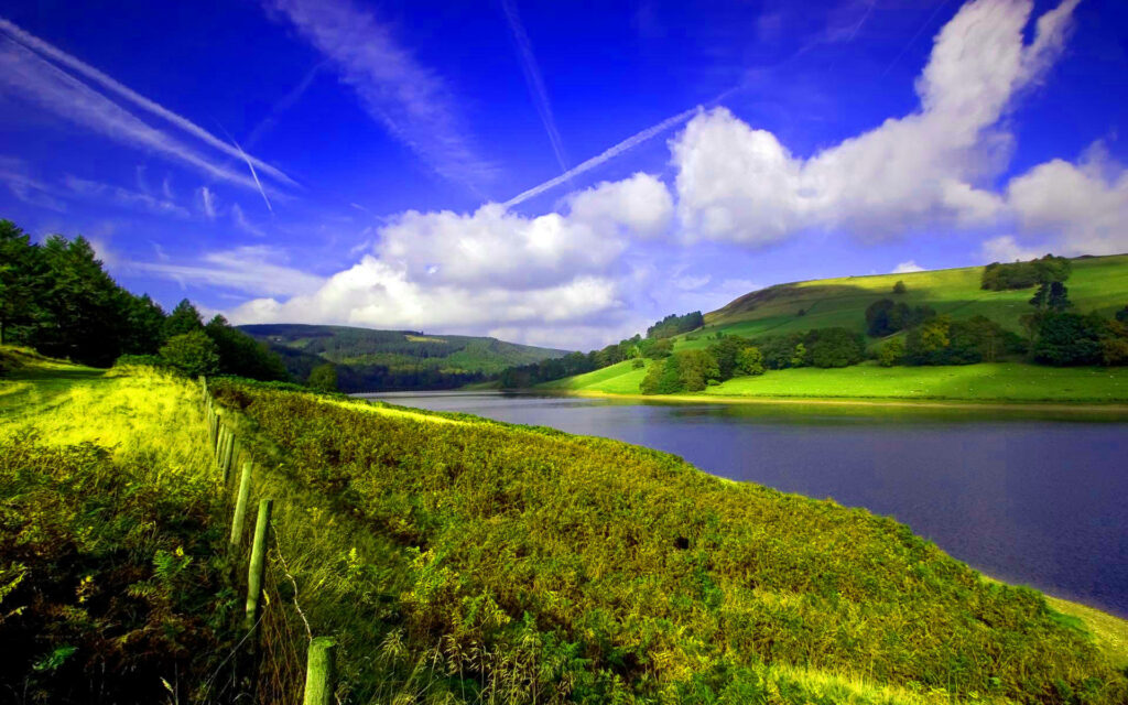 Tranquil River Serenity: HD Landscape Wallpaper with Blue Skies and Lush Green Hills - Background Photo
