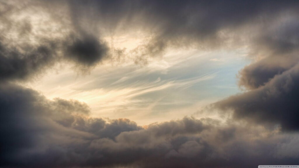Stunning HD Wallpaper: Dark Clouds & Serene Sky Contrast Background