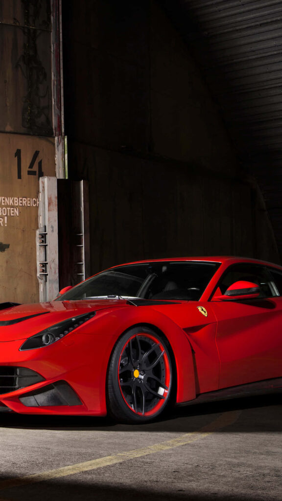 Captivating Night Ambience: Mesmerizing Shot of a Radiant Red Ferrari F12 in a Moody Parking Scenario Wallpaper