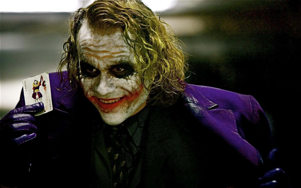 Joker Wallpaper: Eerie Clown Makeup & Menacing Smile Background