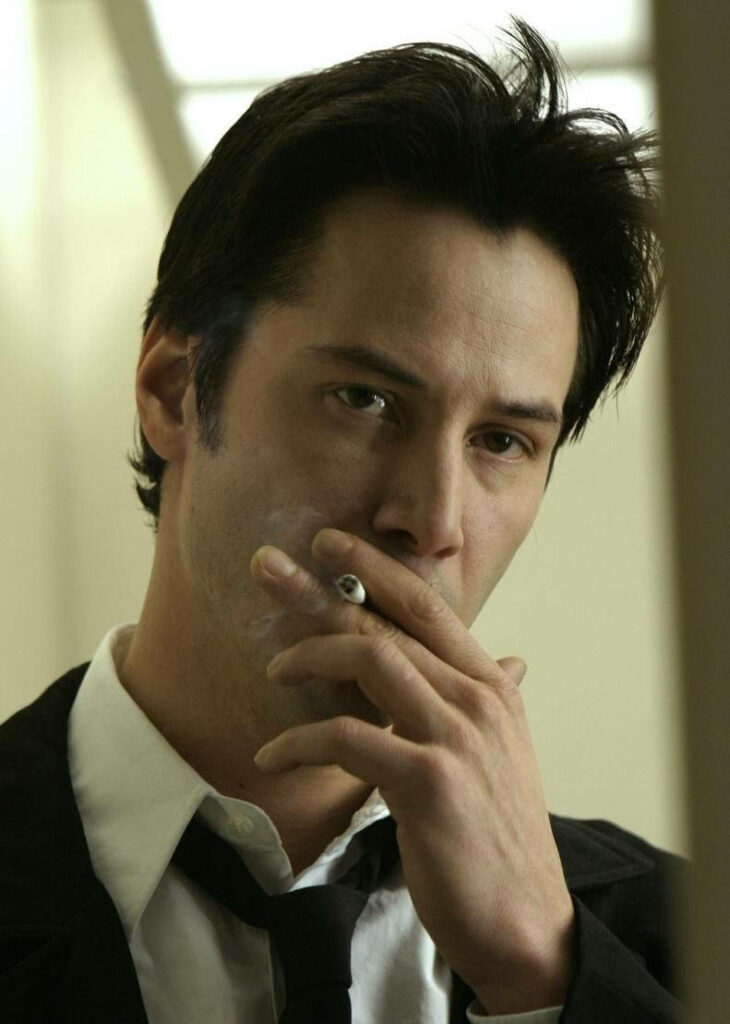 Thoughtful Keanu Reeves Wallpaper: Iconic Style & Enigmatic Presence