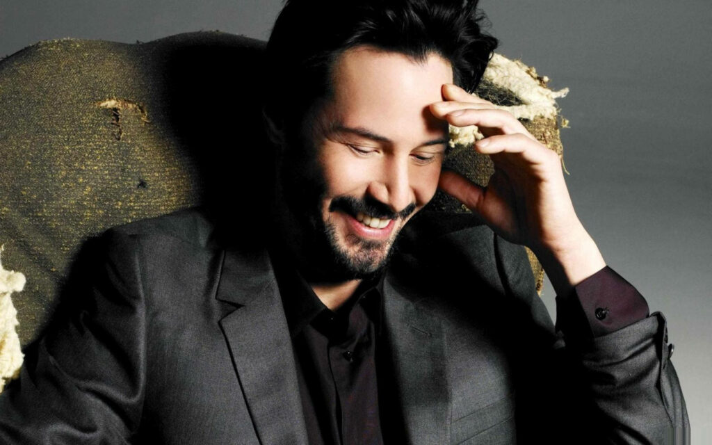 Warm Keanu Reeves Wallpaper: Relaxed & Cheerful in a Suit