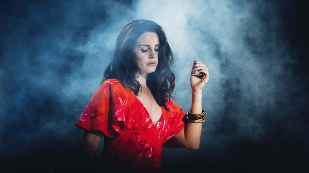 Lana Del Rey in Red Dress: Alluring Smoky Wallpaper Background