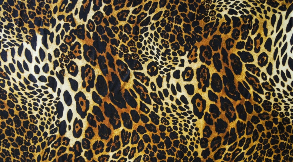 Golden Majesty: A Picturesque Landscape with Adorable Leopard Print Wallpaper