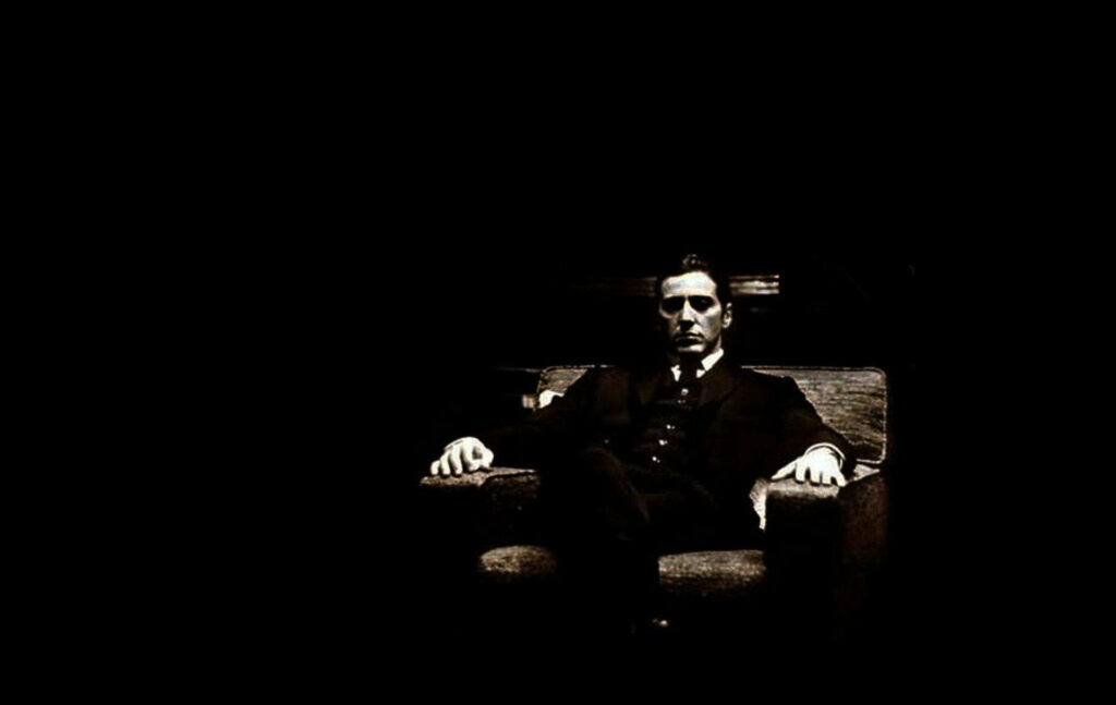 Elegant Michael Corleone Wallpaper: Authority in Dim Light