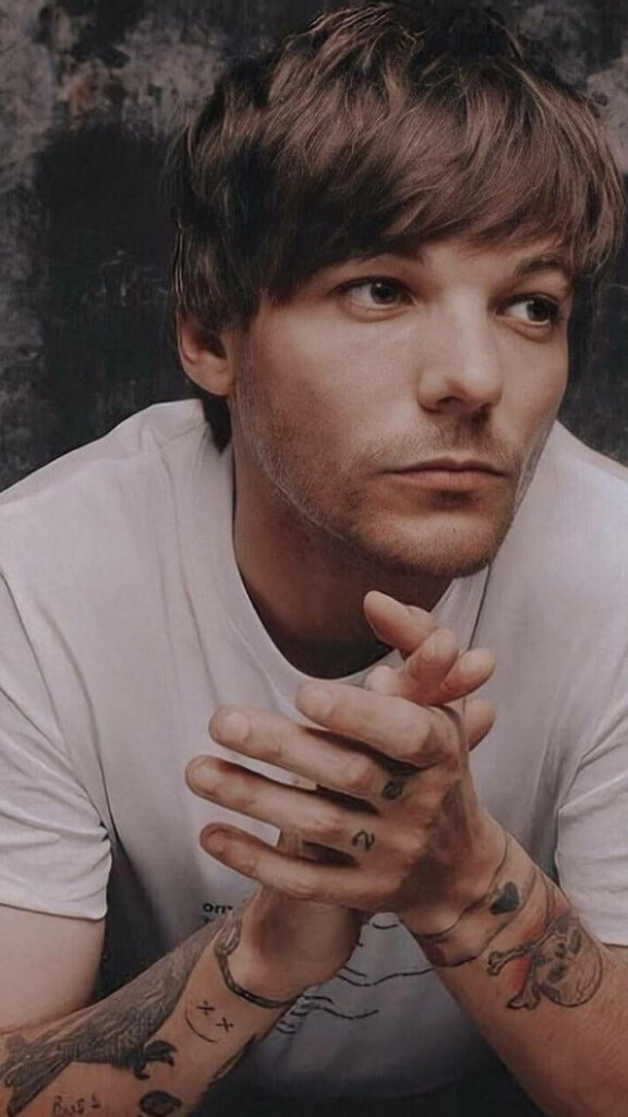 Shot of Louis Tomlinson: Mesmerizing Gaze and Poise in Crisp White Attire Wallpaper