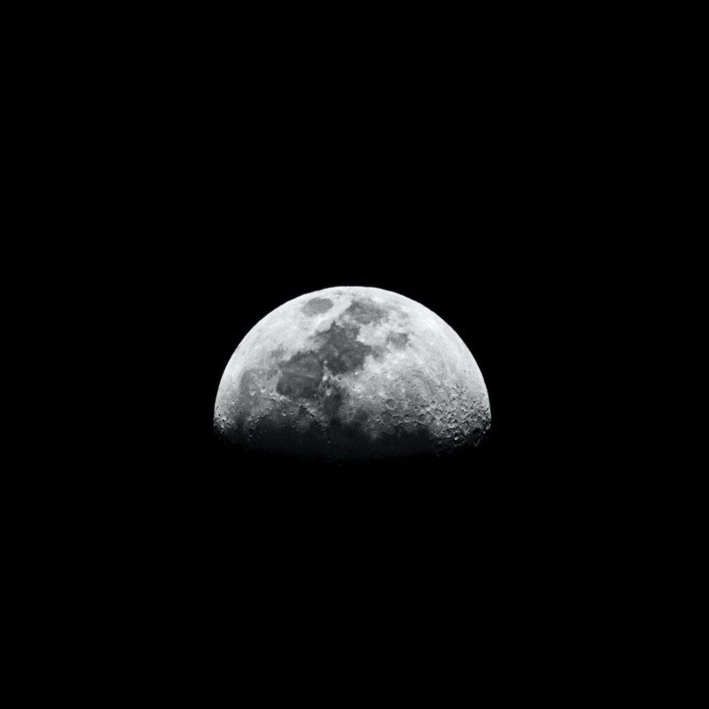 Stunning Moonrise Wallpaper: Illuminated Craters on Dark Space Background