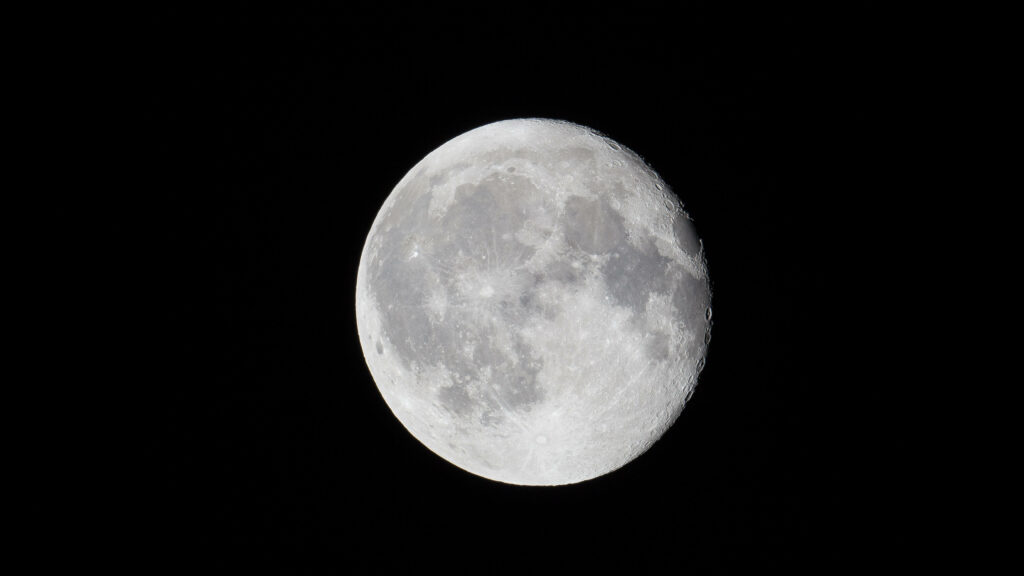 Capturing the Majestic Lunar Beauty: A Moody 4k Background Photo of a Perfectly Zoomed Full Moon in a Gloomy Sky Wallpaper