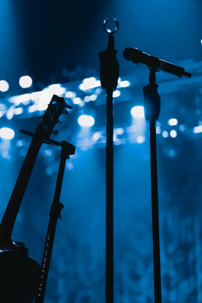 Atmospheric Musical Wallpaper: Microphone & Guitar under Blue Lights