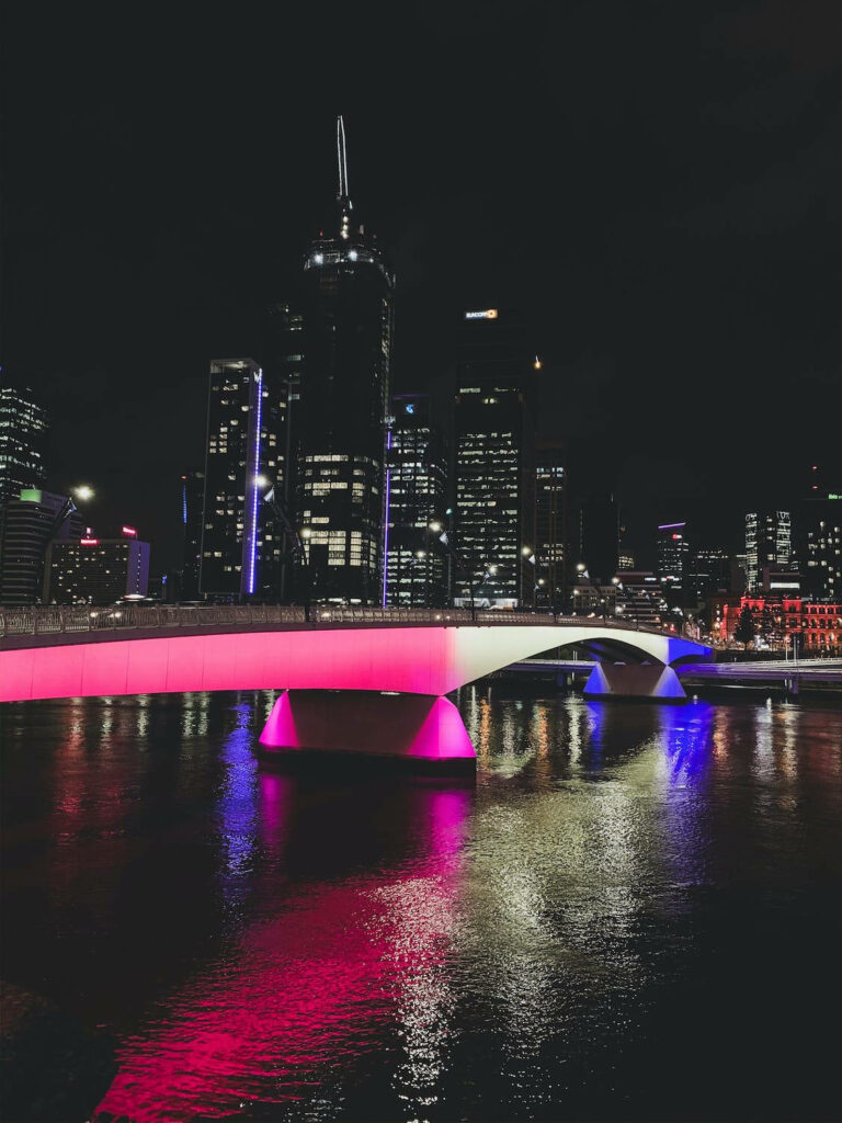 Stunning Night Cityscape: Pink-Lit Bridge & Skyscrapers Wallpaper