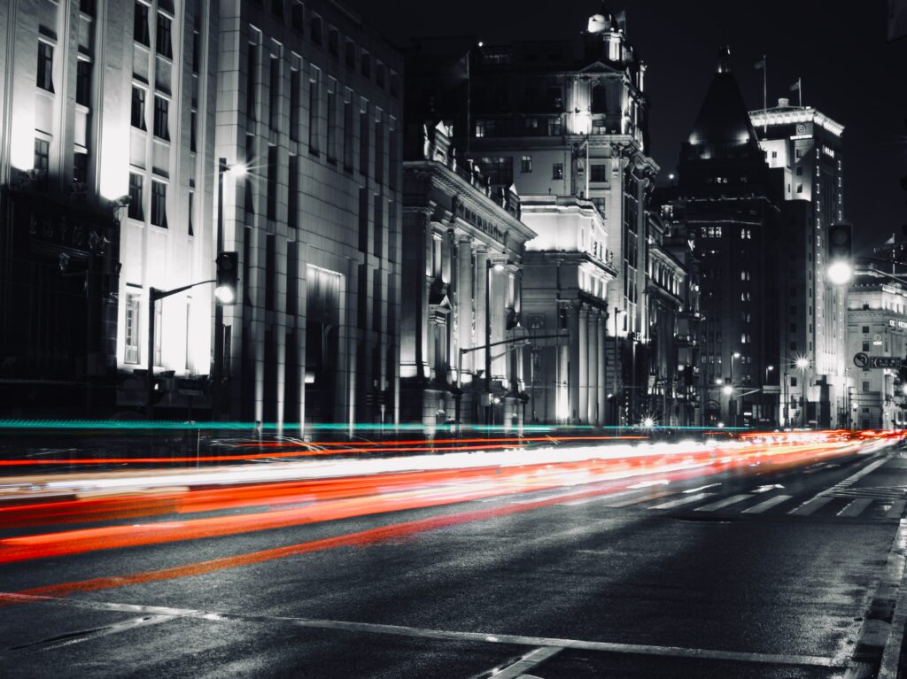Vibrant Night-Time Cityscape: Busy Street with Light Trails Wallpaper