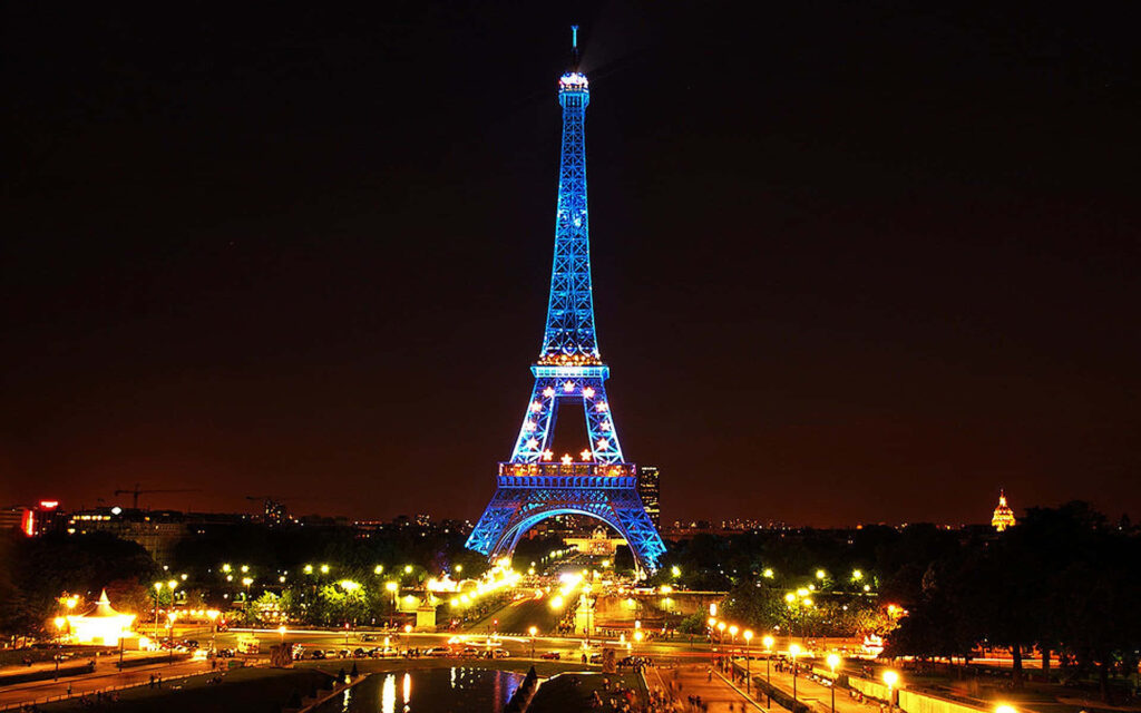 Midnight Magic in Paris: Captivating Shot of the Eiffel Tower Illuminated in Enchanting Blue Hues Wallpaper