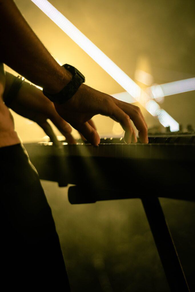 Moody Piano Wallpaper: Hands Playing with Warm Ambient Lighting