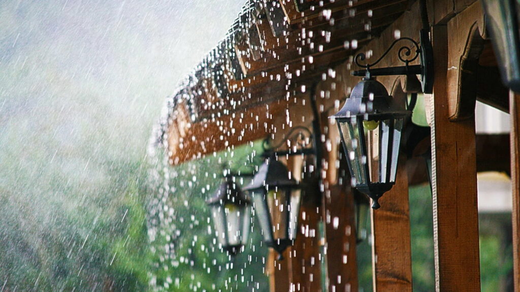 Enchanting Rainfall Captured in a High-Definition Wallpaper: Serene Droplets Descend Upon a Charming Yard House