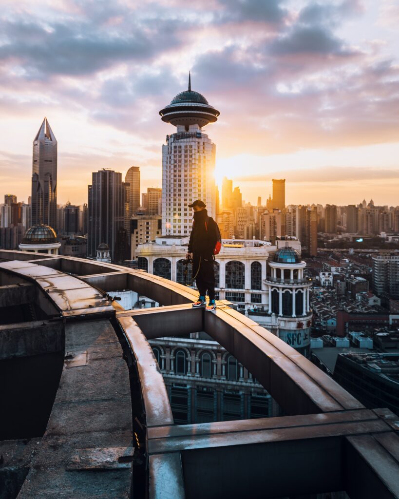 Solitary Rooftop Reflection: Urban Sunset Wallpaper Background