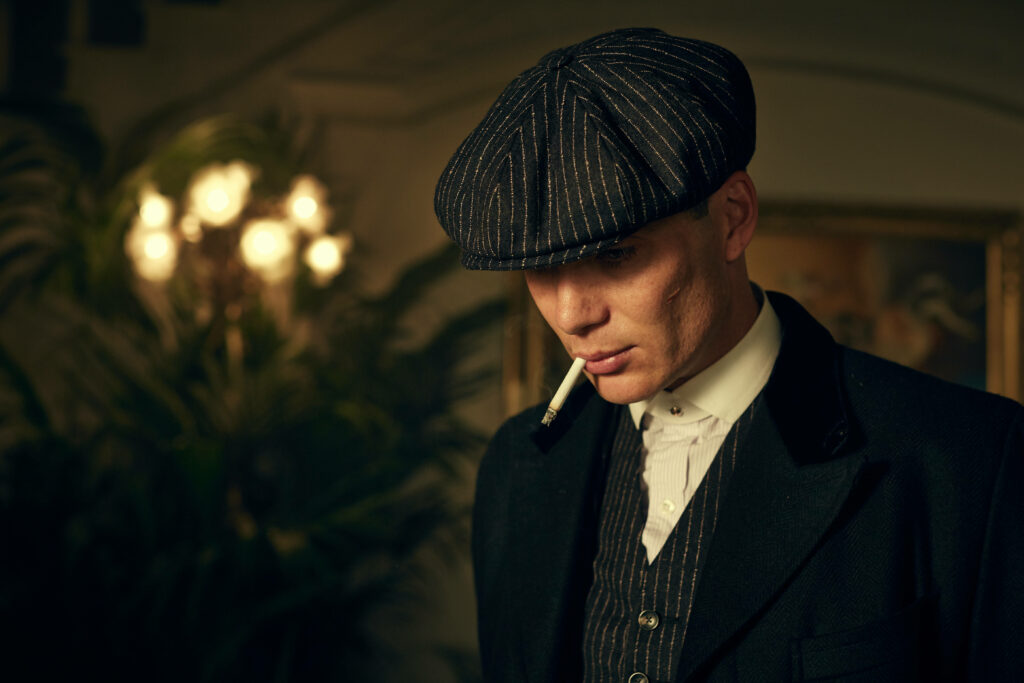 Sharp and Stylish: Tommy Shelby Rocking a Flat Cap in Exquisite Peaky Blinders 8k Backdrop Wallpaper
