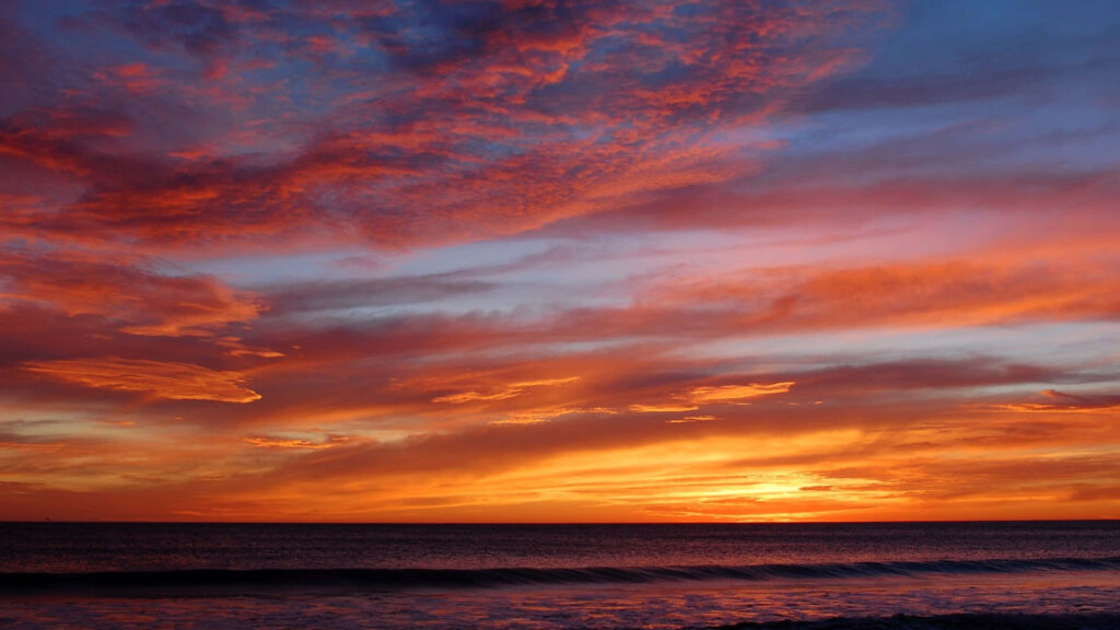 Malibu Magic: Mesmerizing 1440p Orange-Red Sunset over the California Coast Wallpaper