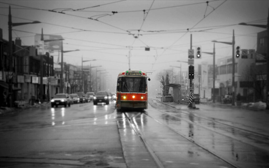Toronto's Electric Bus: Embracing Sustainable Transit in Rainy Urban Landscape Wallpaper