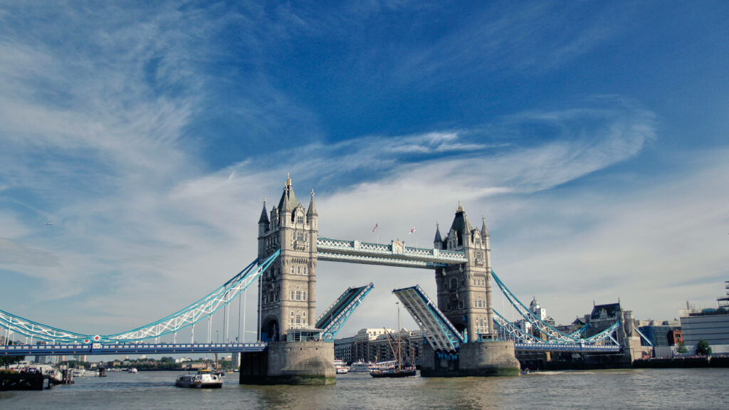 Stunning Tower Bridge Wallpaper: Iconic Design Against Blue Sky