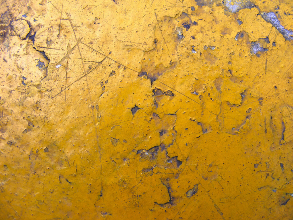 Rustic Elegance: Captivating Grunge Texture Background with Cracking Yellow Paint on a Rough Wall Surface Wallpaper