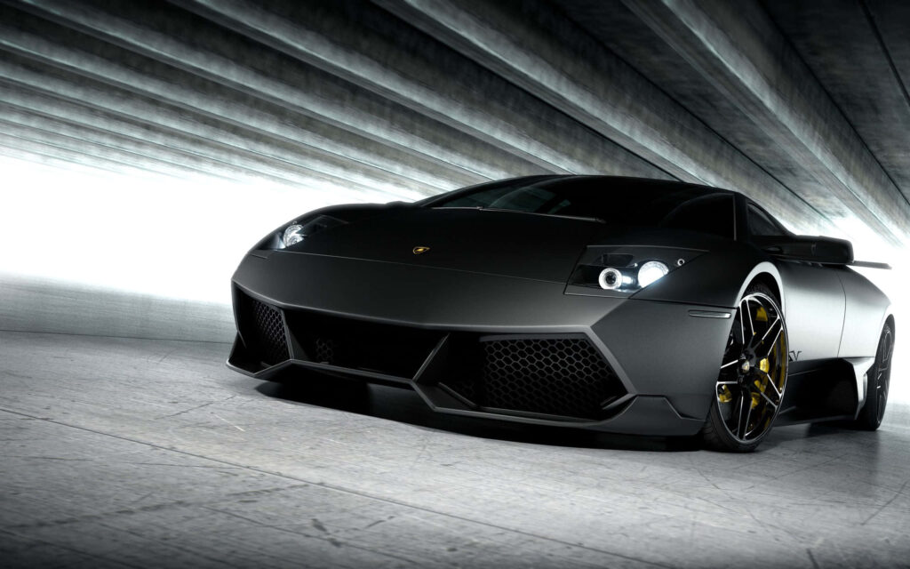 The Ferocious Elegance of a Matte Black Lamborghini Murciélago Racing Machine Wallpaper