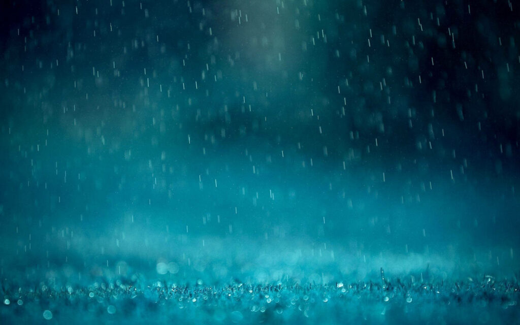 Close-up rain streaks on deep teal background with sparkling bokeh for calming wallpaper view