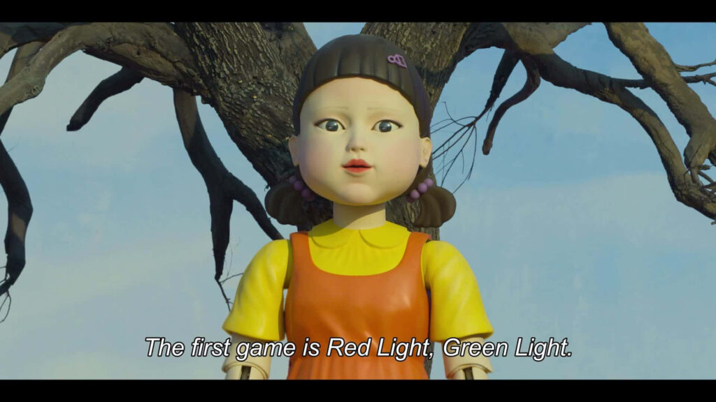 Doll of Destiny: Young-hee Takes Control in the Squid Game's Start, Red Light, Green Light Wallpaper