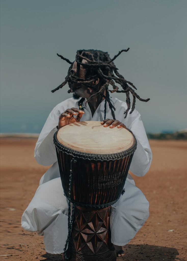 Passionate Musician Playing Drum: Captivating Outdoor Wallpaper