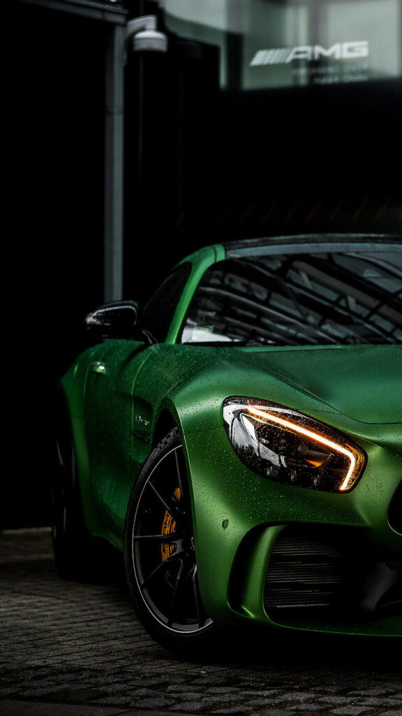 Captivating Shot of Green Mercedes-AMG Headlight Perfect for AMG iPhone Backgrounds Wallpaper