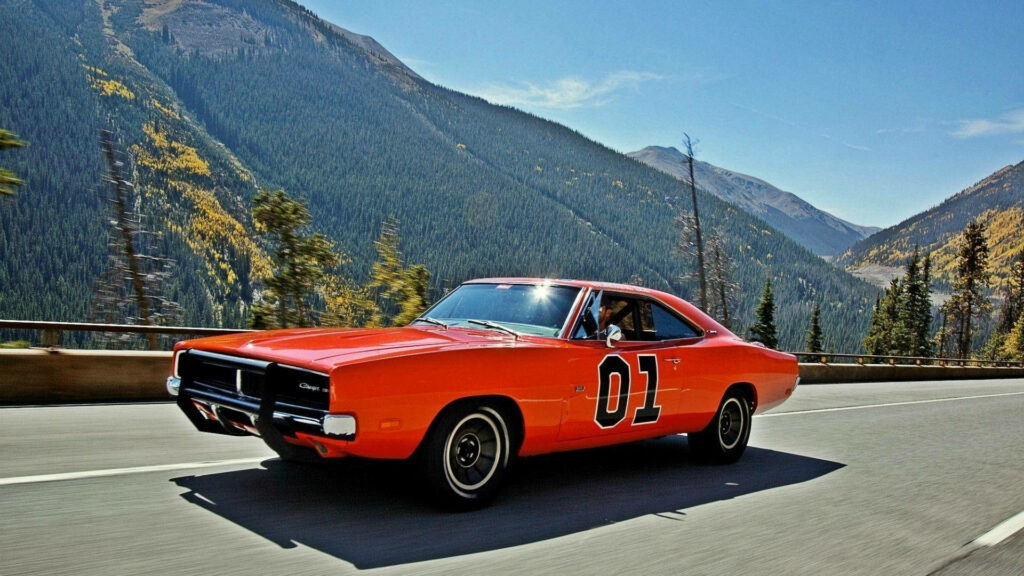 Dukes of Hazzard's Iconic General Lee on a Thrilling Road Chase Under a Radiant Sun Wallpaper