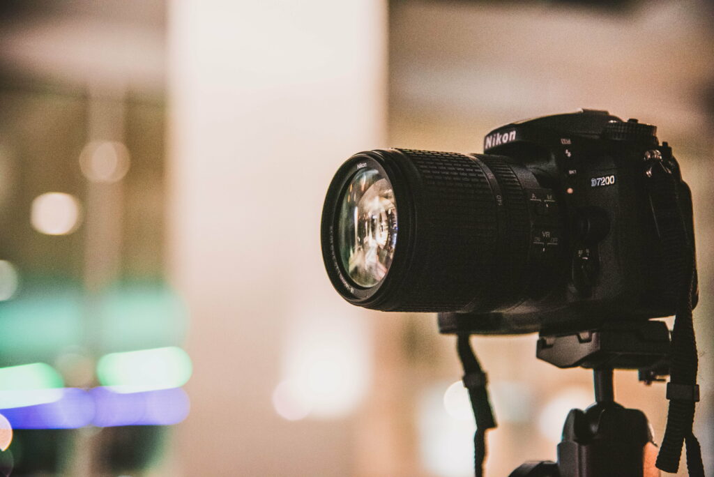Capturing Clarity: Focusing on the World Through a Black Nikon DSLR Wallpaper