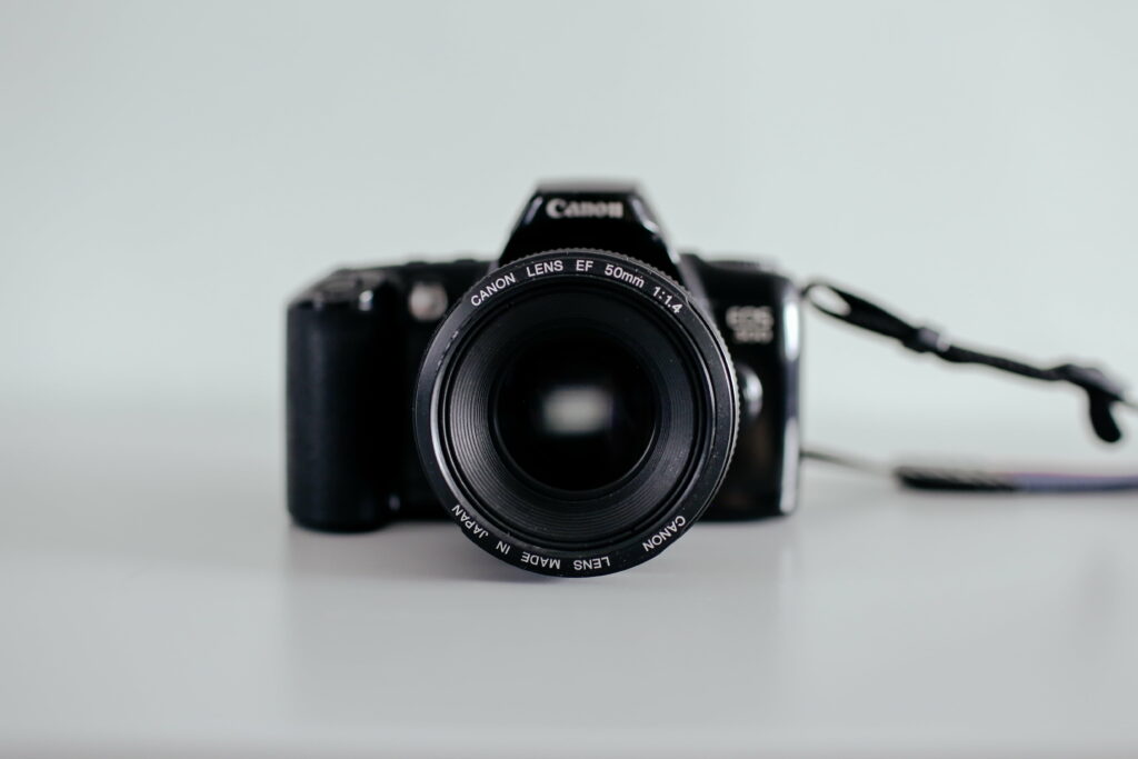 Capturing Life's Details: Artistic Focus on Stunning Black Canon DSLR Camera - Striking 5K Wallpaper Background