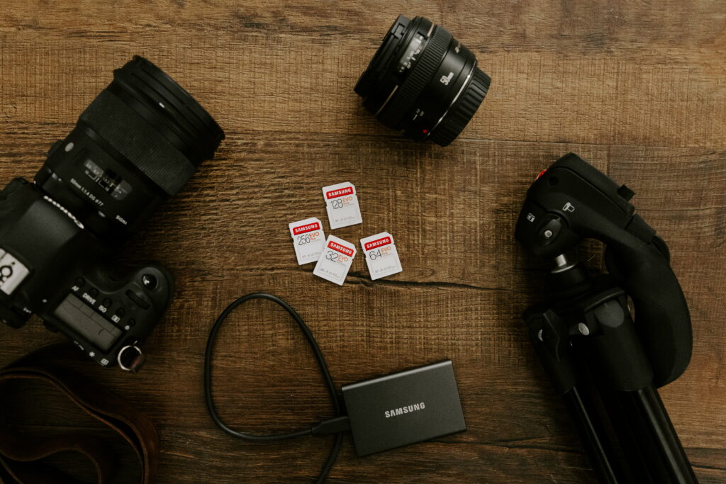 Capturing Life's Moments: Black Nikon DSLR Camera on Brown Wooden Table against Wallpaper