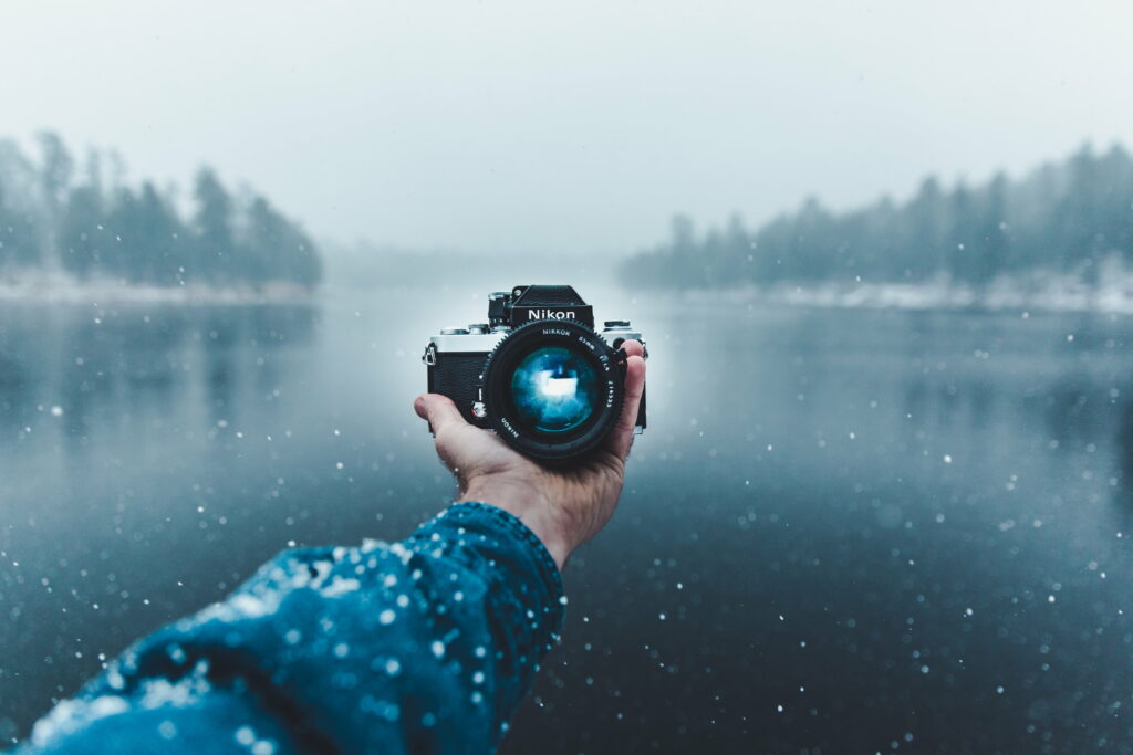 Camera Clicks and Wallpaper Tricks: A Nikon DSLR Selfie against a Stunning Background