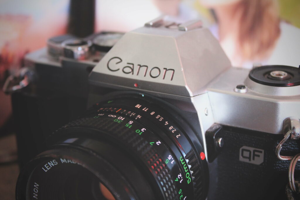 Capturing Moments: Sleek Nikon DSLR Camera poised on Table with Stunning 5K Wallpaper Background